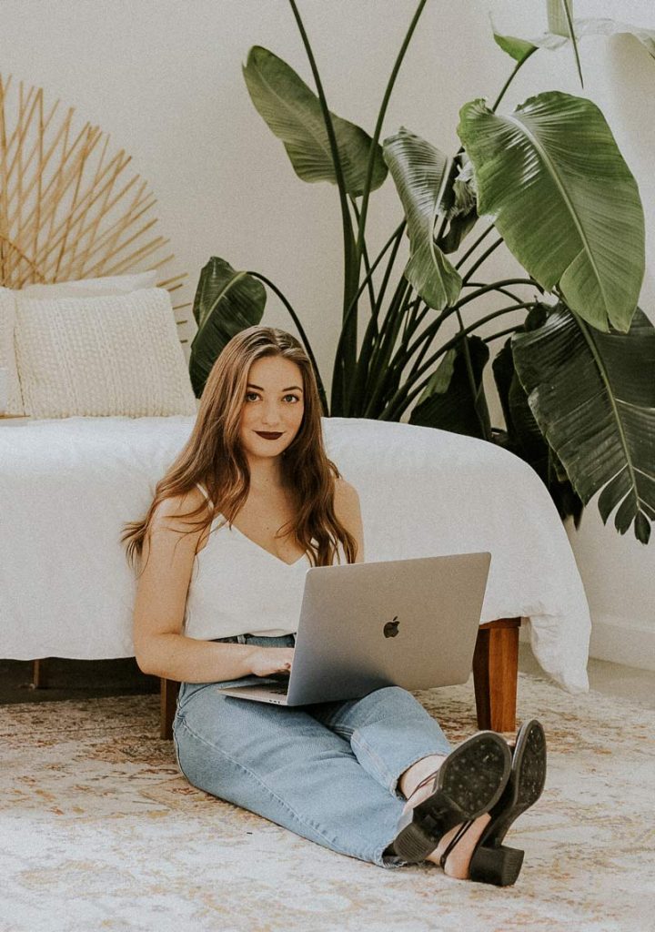 carissa sitting and holding a laptop